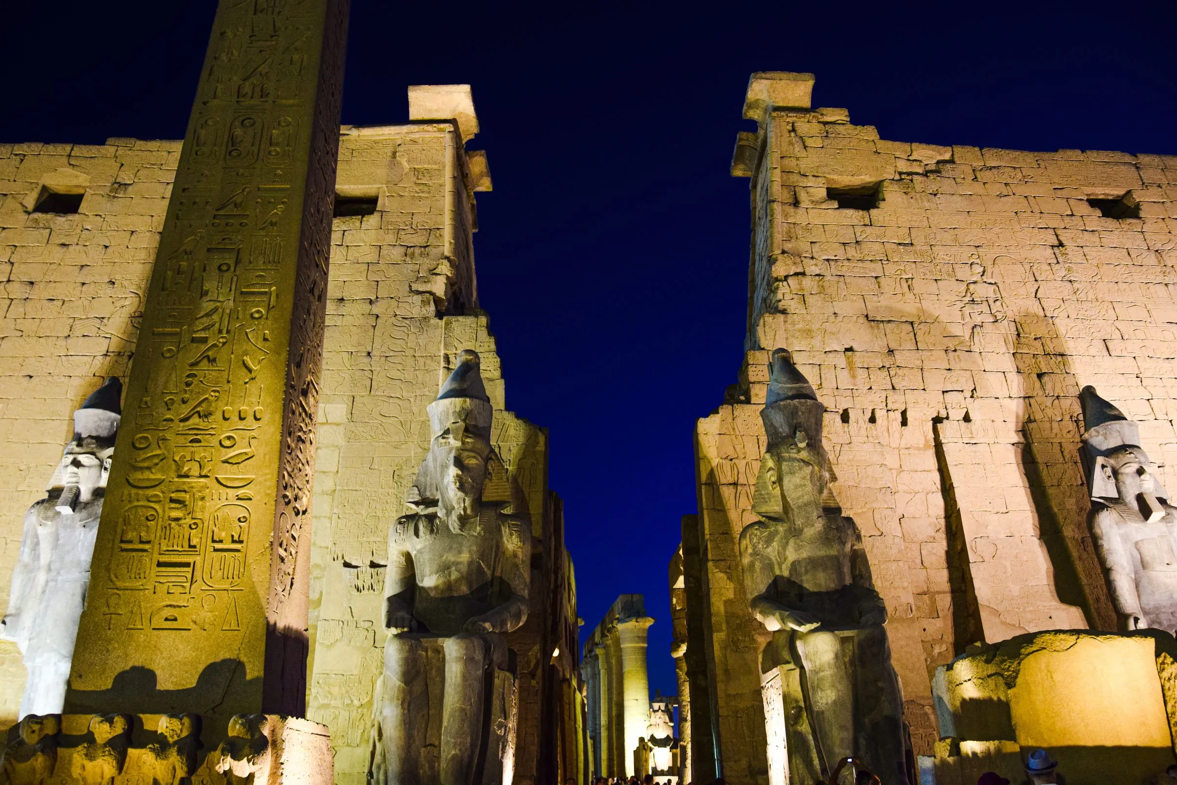 The entrance pylon of Luxor Temple lit at night, Luxor, Egypt